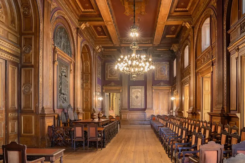 Sala Assembleias Gerais at Palácio da Bolsa, showing the assembly chamber configured by BTQ Events as a registration and breakout space for a corporate conference programme