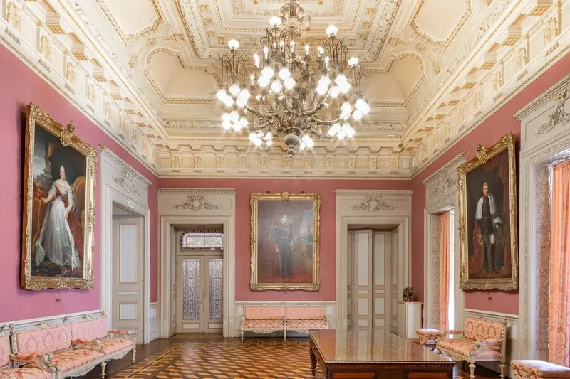Sala dos Retratos at Palácio da Bolsa, showing the heritage-portrait chamber used by BTQ Events as a VIP hold and exhibition space alongside a main programme in Pátio das Nações