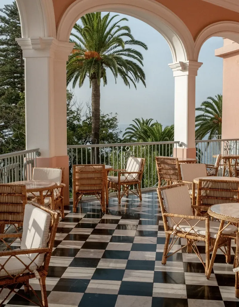 Reid's Palace Tea Library · Garden Verandah · arched colonnaded terrace with chequered marble floor and rattan furniture above Funchal Bay