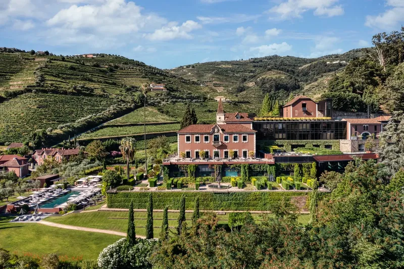 Six Senses Douro Valley aerial · restored 19th-century quinta on the terraced vineyard hillside above the Douro river