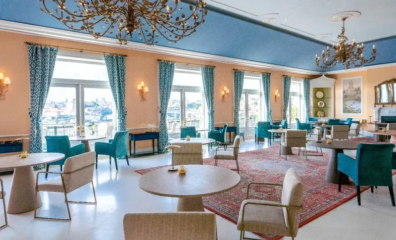 The Yeatman Library lounge with blue-painted ceiling, chandeliers, arched windows framing the Douro, deep sofas and decorative panelling, used by BTQ Events as a VIP arrival hold and post-dinner retreat
