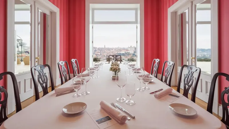 The Yeatman private dining room with long candle-lit table, pink curtains and Porto-skyline view, available for Two-Michelin-star Gastronomic Restaurant private hire under Chef Ricardo Costa and used by BTQ Events for wine-pairing corporate gala dinners